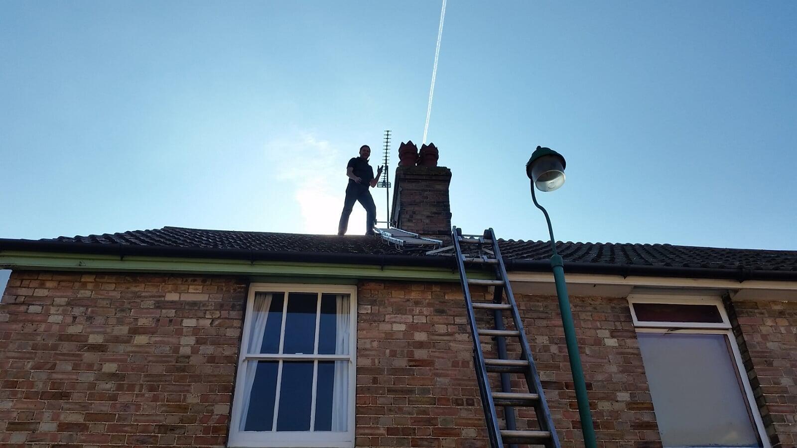 Up on the roof fitting a cowl