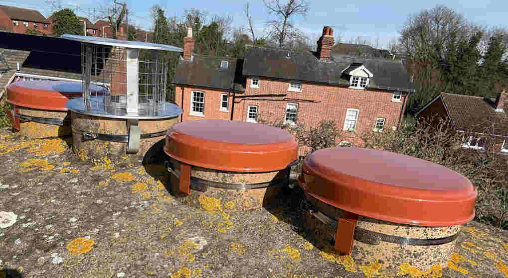 Capping cowls fitted to small pots bedded in cement flaunching