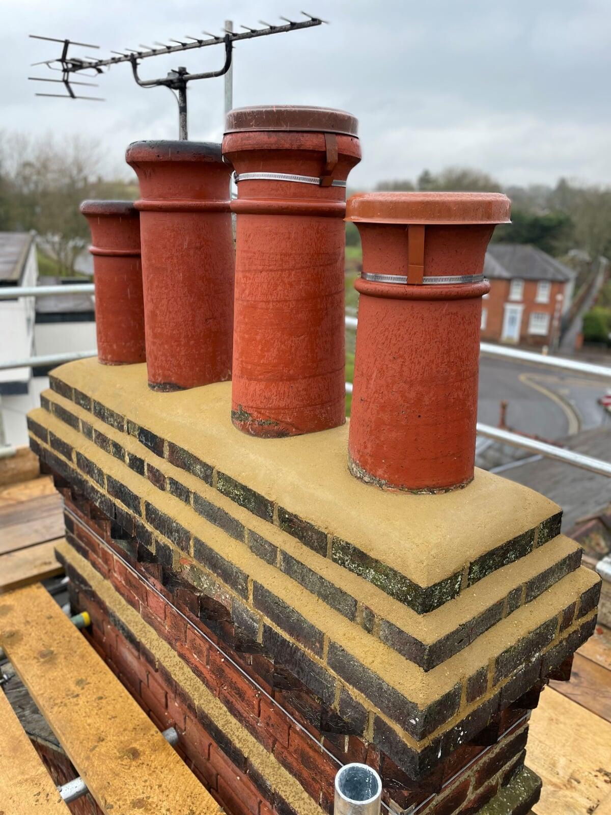 Chimney stack rebuilt and flaunching replaced. Capping cowls fitted.