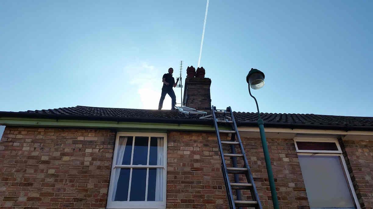 Up on the roof fitting a cowl