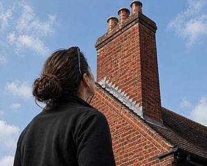 Woman looking at chimney pots